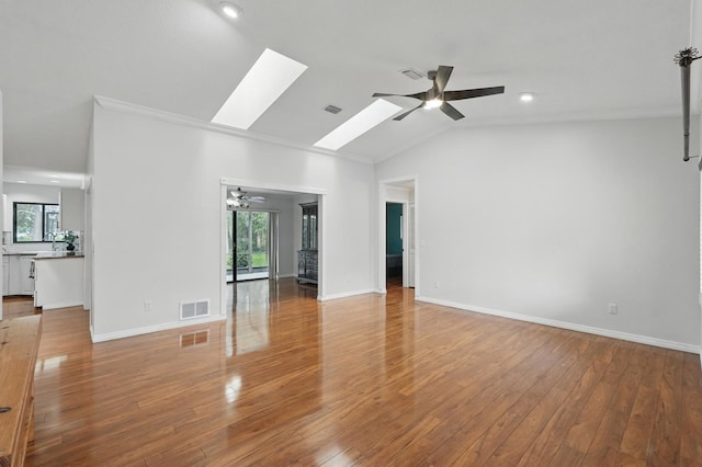 131 Boulder Rock Dr, Palm Coast, FL 32137 - unfurnished living room with ceiling fan, plenty of natural light, light wood finished floors, vaulted ceiling, and a skylight