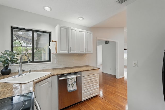 131 Boulder Rock Dr, Palm Coast, FL 32137 - kitchen featuring dishwasher, backsplash, light wood-style floors, and light countertops
