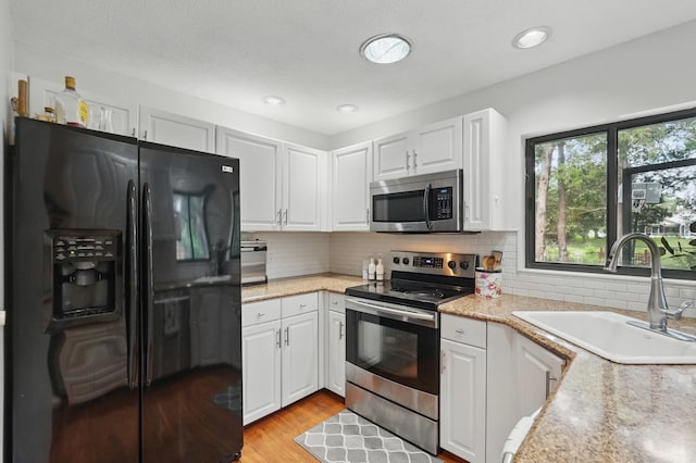 131 Boulder Rock Dr, Palm Coast, FL 32137 - kitchen with stainless steel appliances, light countertops, white cabinets, and recessed lighting