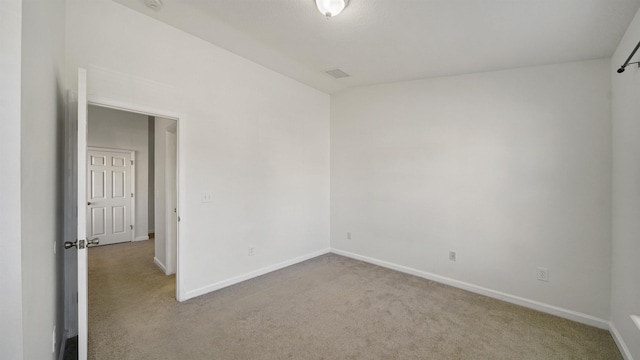 empty room featuring light colored carpet