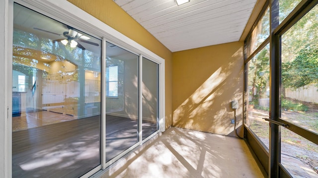 unfurnished sunroom featuring ceiling fan and wood ceiling