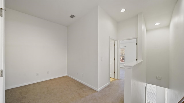 corridor with light colored carpet