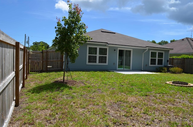 35 Putter Dr, Palm Coast, FL 32164 - back of property with a fenced backyard, a patio, stucco siding, an outdoor fire pit, and roof with shingles