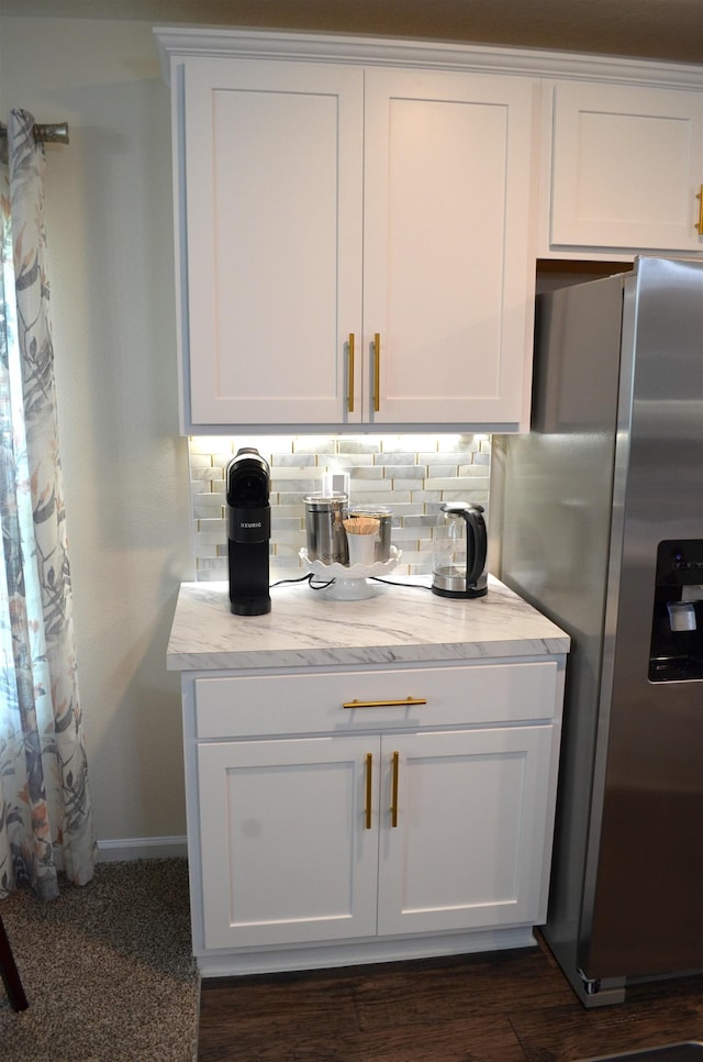 35 Putter Dr, Palm Coast, FL 32164 - kitchen featuring stainless steel fridge, decorative backsplash, white cabinetry, and light stone counters
