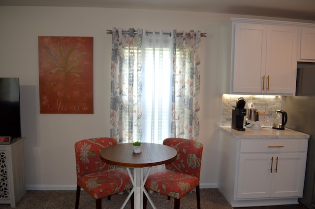 35 Putter Dr, Palm Coast, FL 32164 - dining area with carpet floors and baseboards