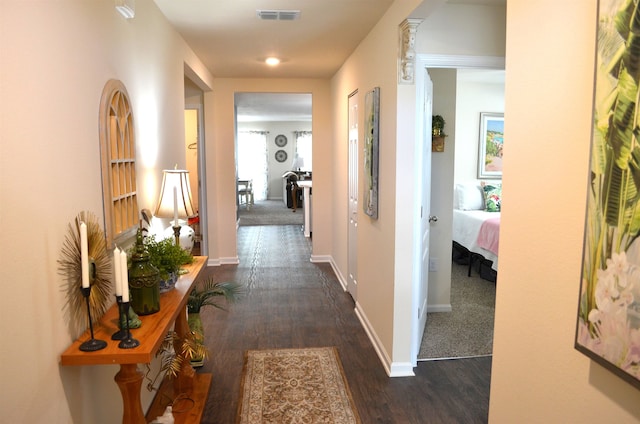 35 Putter Dr, Palm Coast, FL 32164 - hallway with dark wood-type flooring and baseboards