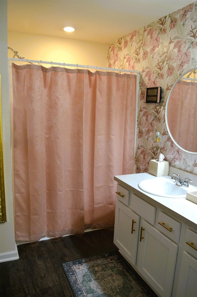 35 Putter Dr, Palm Coast, FL 32164 - bathroom with wallpapered walls, wood finished floors, vanity, and a shower with shower curtain