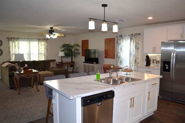 35 Putter Dr, Palm Coast, FL 32164 - kitchen featuring stainless steel appliances, open floor plan, light countertops, a kitchen island with sink, and recessed lighting