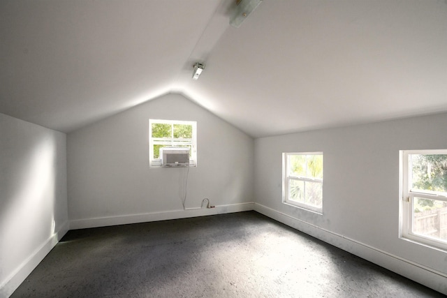 bonus room with cooling unit and lofted ceiling