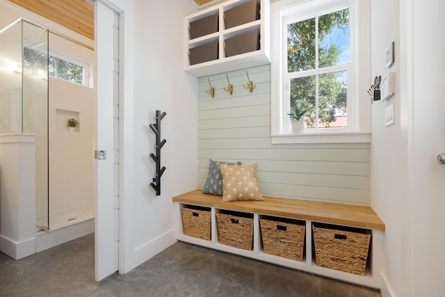 mudroom featuring wooden walls