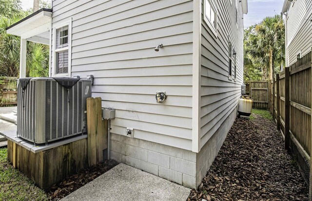 view of side of home with central AC