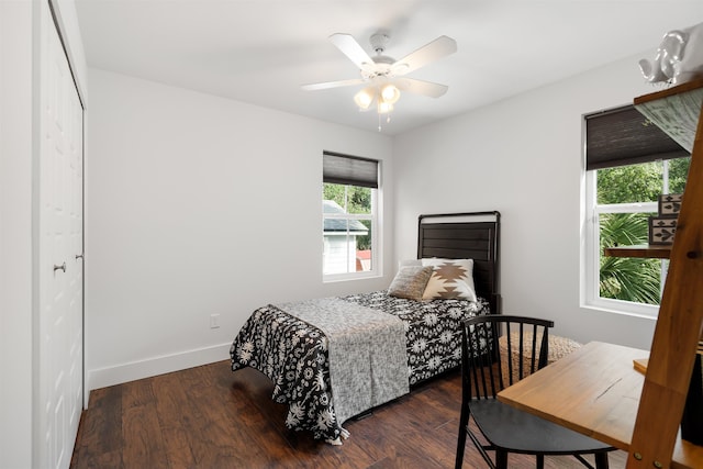 bedroom featuring ceiling fan, a closet, and dark wood-type flooring