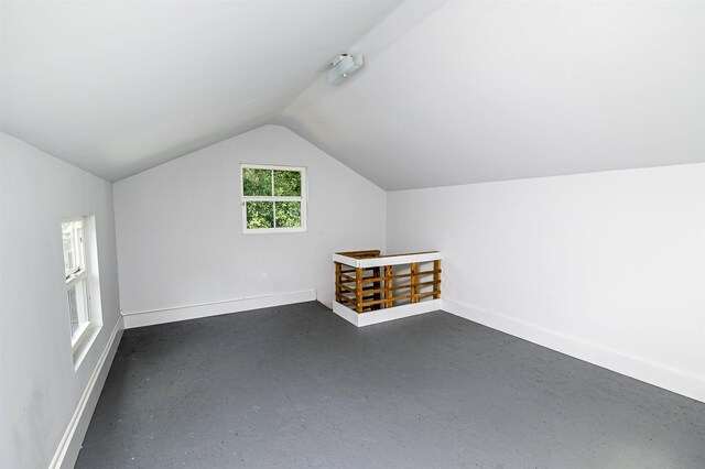 additional living space featuring lofted ceiling