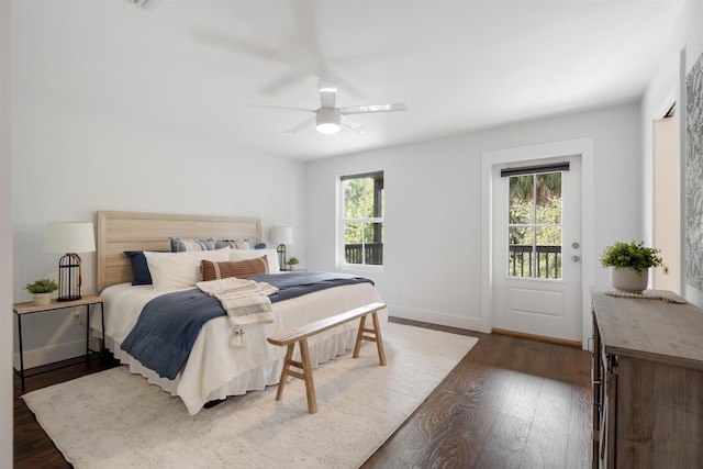 bedroom featuring ceiling fan, access to exterior, dark wood-type flooring, and multiple windows