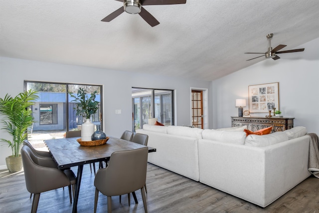 living room featuring hardwood / wood-style floors, plenty of natural light, ceiling fan, and vaulted ceiling