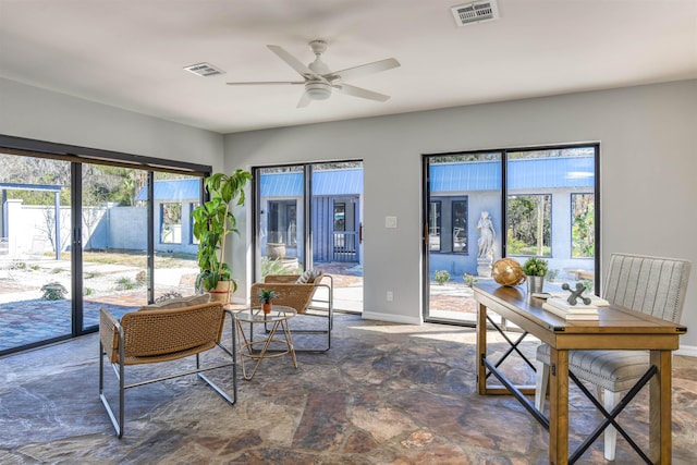 sunroom with plenty of natural light and ceiling fan