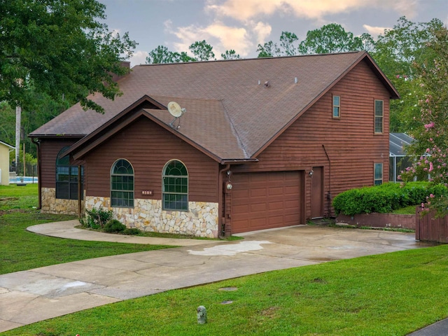 view of front of property featuring a garage and a front lawn