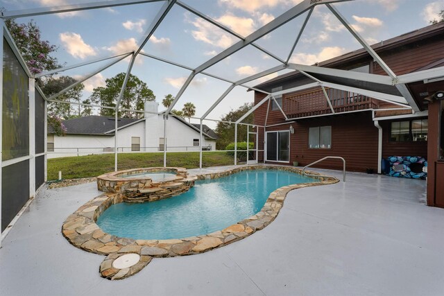 view of pool featuring an in ground hot tub, a patio, and a lanai