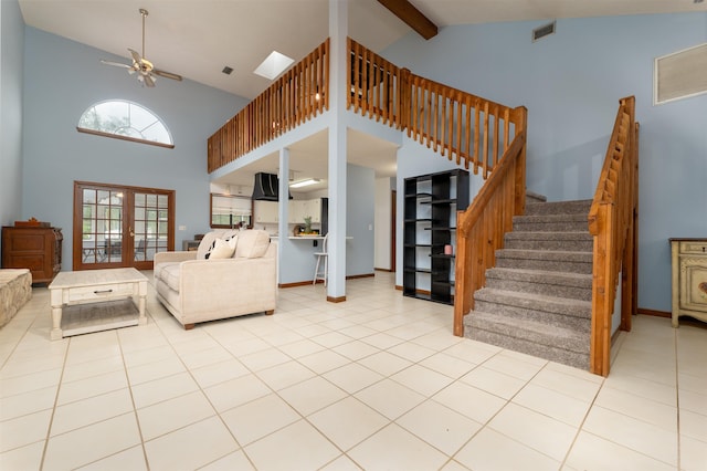 tiled living room featuring french doors, high vaulted ceiling, ceiling fan, and beam ceiling