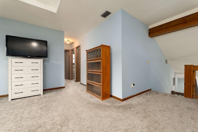 unfurnished living room featuring light colored carpet, lofted ceiling, and a textured ceiling