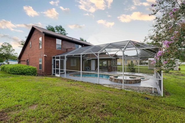 rear view of house featuring a swimming pool with hot tub, a lanai, and a yard