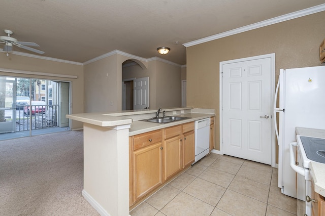 kitchen with sink, light carpet, white appliances, and kitchen peninsula