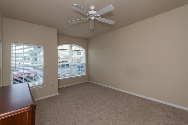 unfurnished room featuring light carpet and ceiling fan