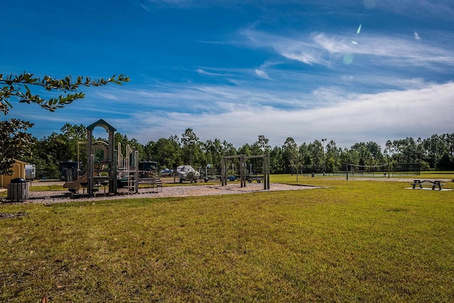 view of play area featuring a lawn and volleyball court