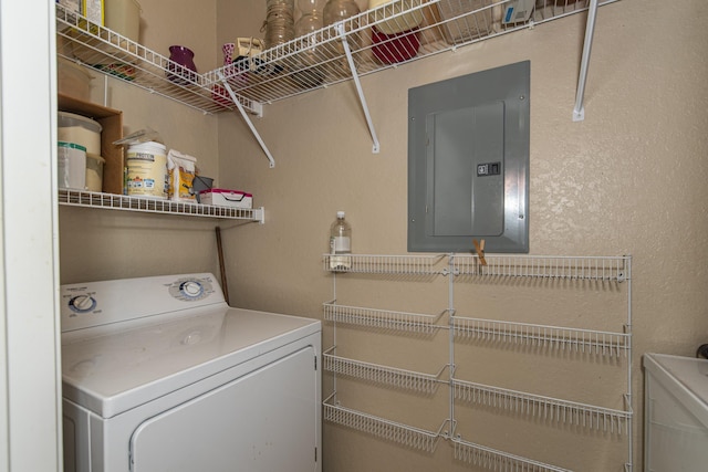 clothes washing area with washing machine and clothes dryer and electric panel