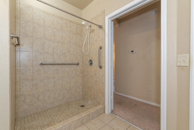 bathroom with tiled shower and tile patterned floors