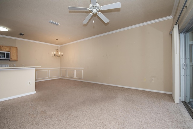 interior space with crown molding, ceiling fan with notable chandelier, and light colored carpet