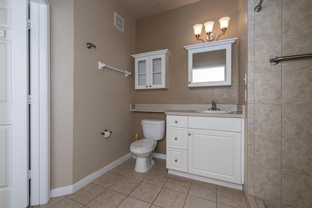 bathroom with vanity, tile patterned flooring, and toilet