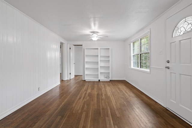 interior space with ceiling fan, dark hardwood / wood-style flooring, and ornamental molding