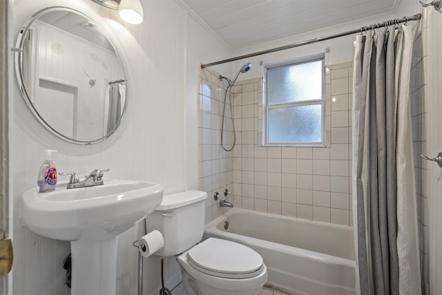 full bathroom with sink, toilet, shower / bath combo with shower curtain, and ornamental molding