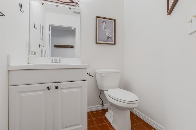 half bath with toilet, visible vents, baseboards, vanity, and tile patterned floors