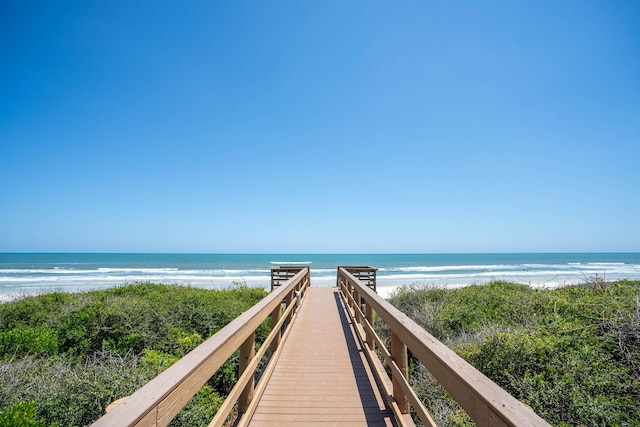 view of property's community featuring a beach view and a water view