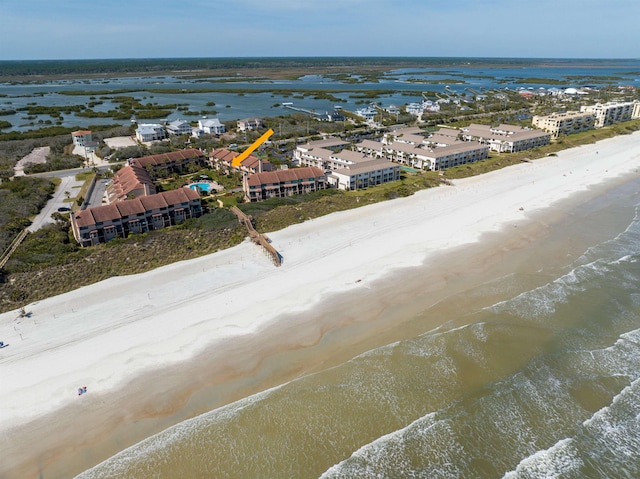 birds eye view of property with a beach view and a water view