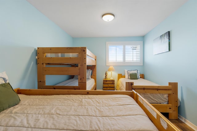 bedroom featuring wood finished floors and baseboards