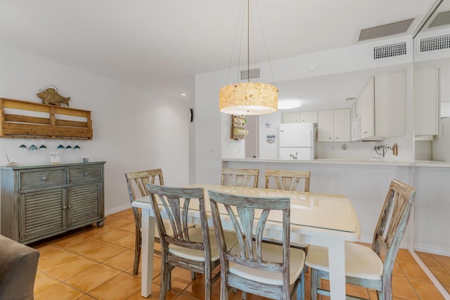 dining area featuring light tile patterned floors and visible vents