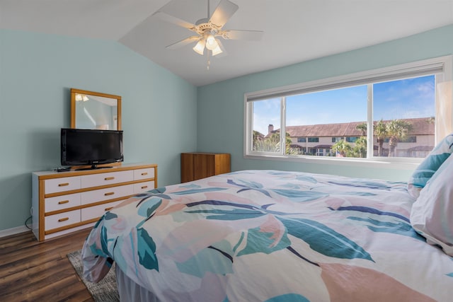 bedroom featuring lofted ceiling, ceiling fan, baseboards, and dark wood finished floors