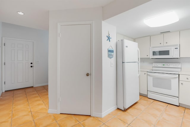 kitchen featuring light countertops, white cabinetry, light tile patterned flooring, white appliances, and baseboards