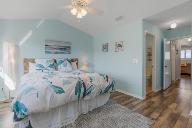 bedroom featuring lofted ceiling, visible vents, baseboards, and wood finished floors