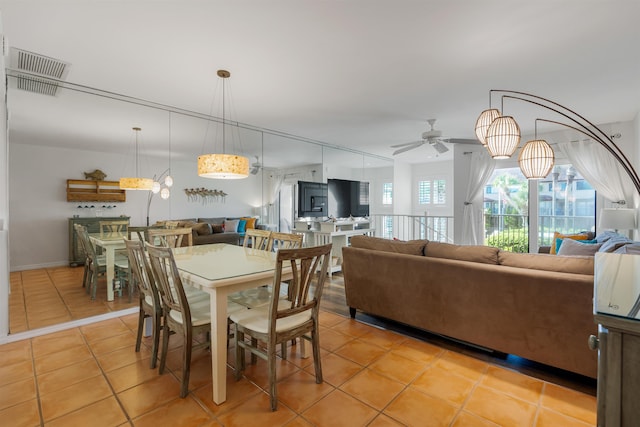 dining space featuring light tile patterned floors, visible vents, and a ceiling fan