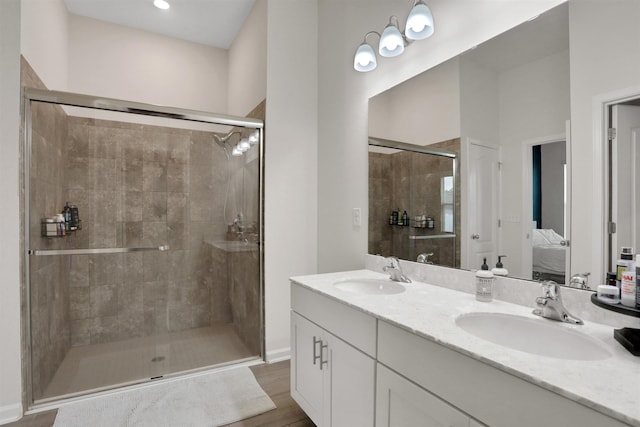 123 Hickory Ridge Rd, Saint Augustine, FL 32084 - ensuite bathroom featuring a stall shower, double vanity, and wood finished floors