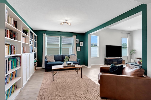 living room featuring a textured ceiling and light hardwood / wood-style flooring