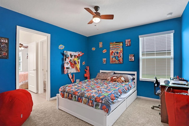 carpeted bedroom featuring ceiling fan and ensuite bathroom