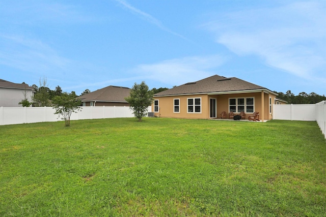 back of house with a yard