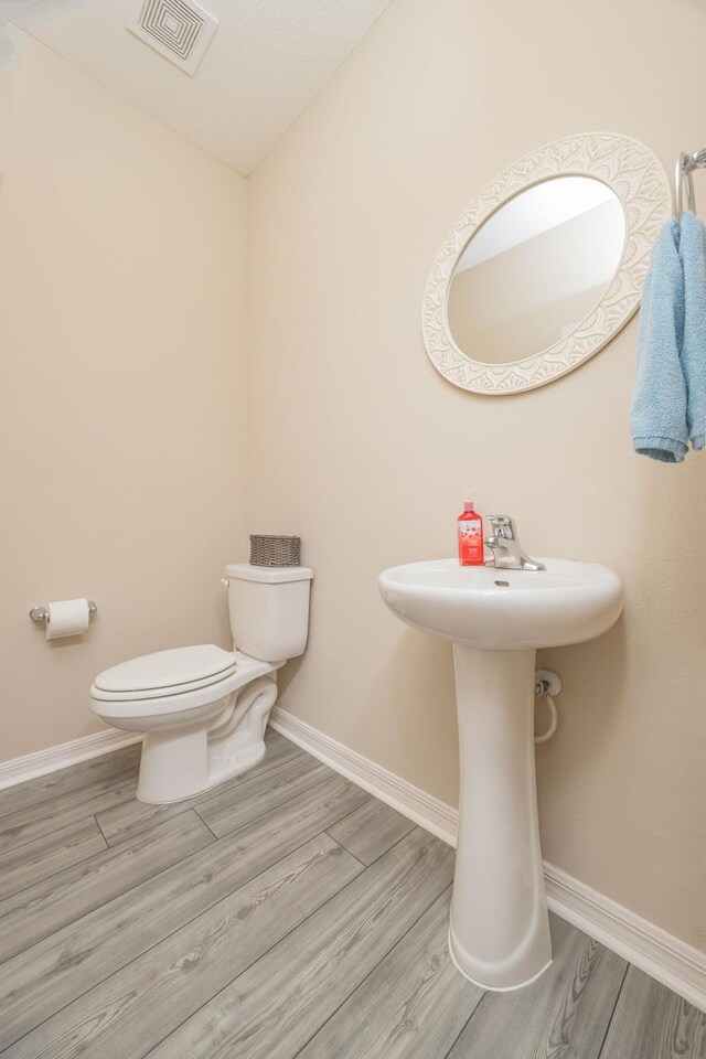 101 Sailors Landing Ct, Saint Augustine, FL 32084 - half bathroom featuring baseboards, visible vents, and wood finished floors