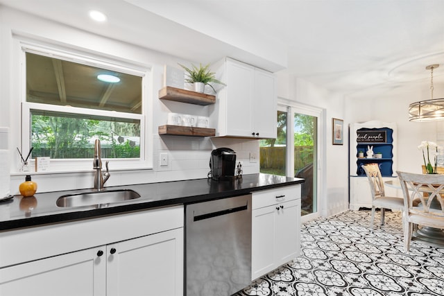 kitchen featuring dishwasher, white cabinetry, plenty of natural light, and sink