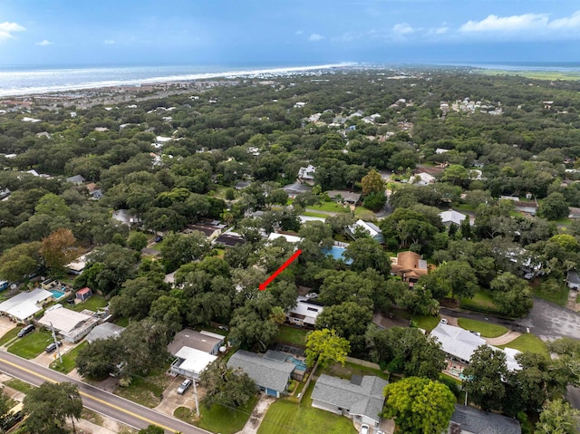 birds eye view of property featuring a water view and a beach view